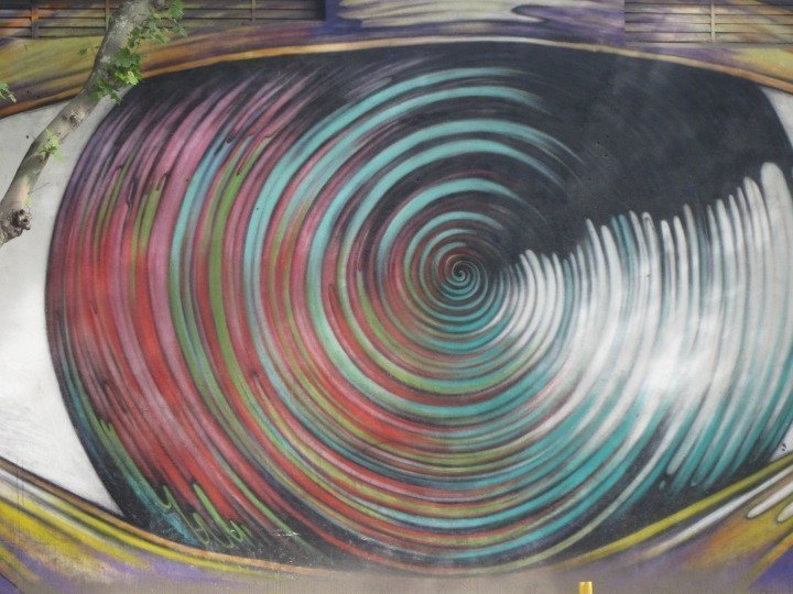 Mural of eye shape with a spiral design for the iris of the eye.