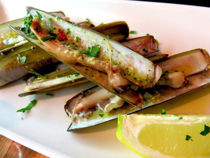 Tapas in Barri Gotic district of Barcelona - navalles (razor clams) with lemon - delicious treat at Taller de Tapas in Barcelona