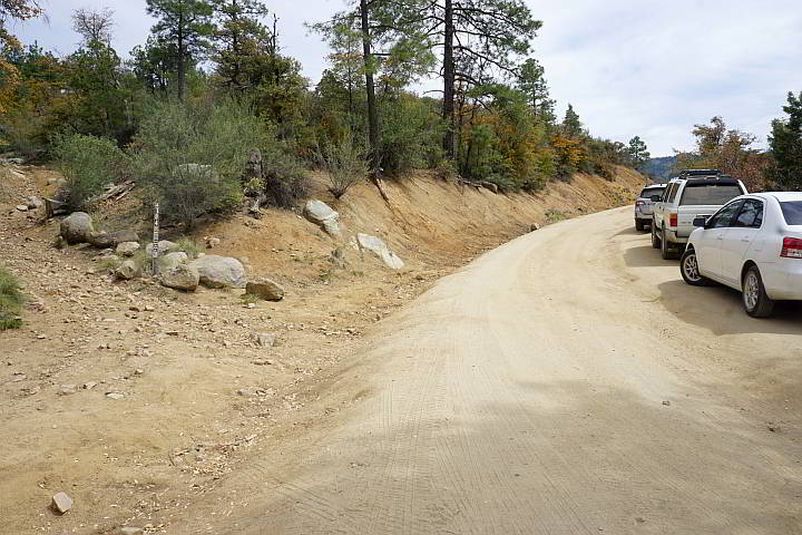 Vehicles parked along Wolf Creek Rd - dirt road