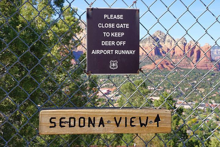 Gate at Sedona View Trail with sign reminding hikers to keep gate closed to keep deer off airport runway