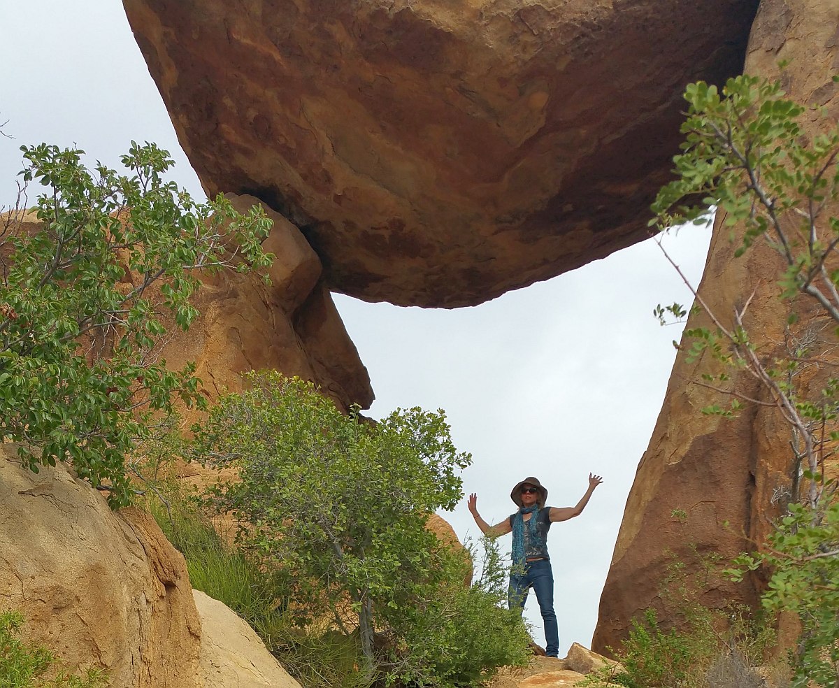 Susan Moore standing below Balanced Rock at Grapevine Trail Big Bend.
