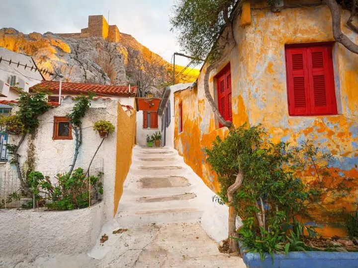 Anafiotika neighborhood has houses with red shutters and red tile rooftops, it is among the best places to see in Athens.