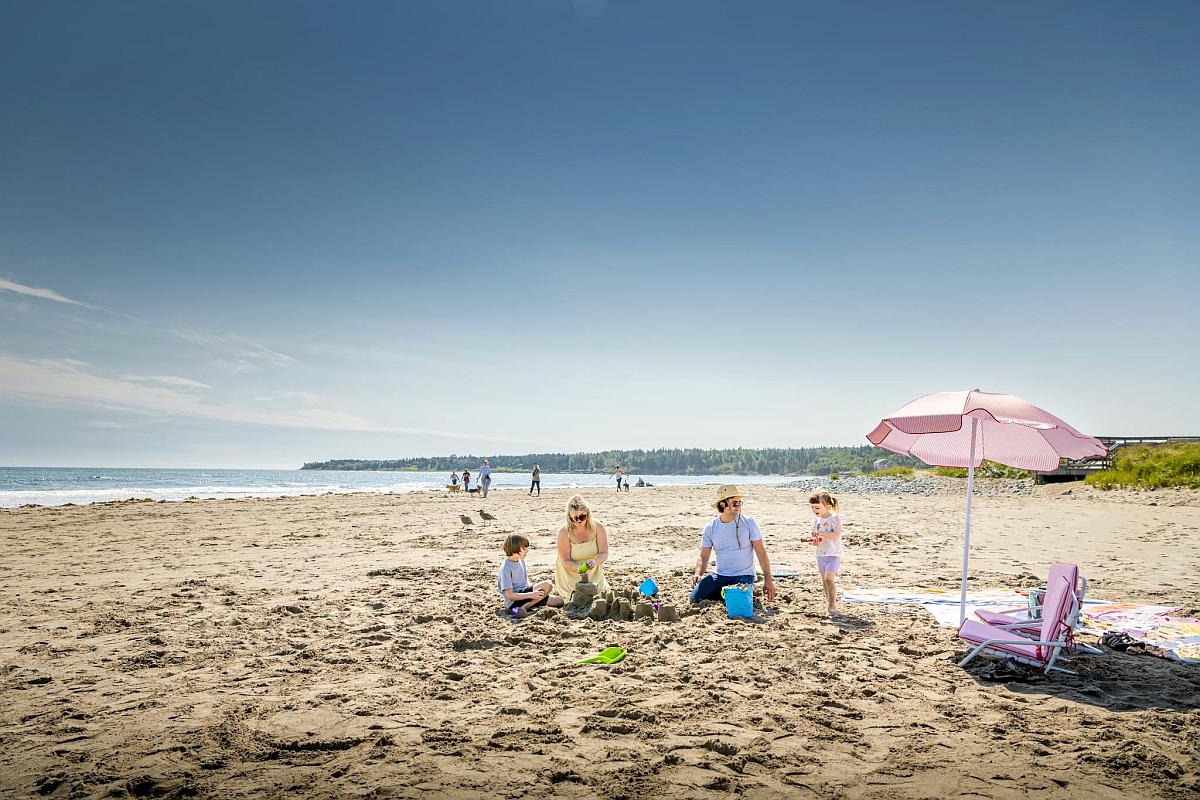 Family fun building sand castles at Rainbow Haven Beach.