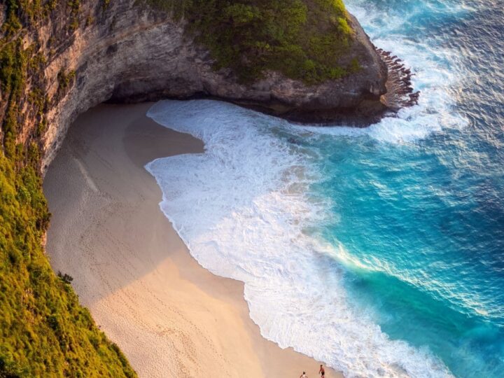 Bali beach and blue water along cliff.