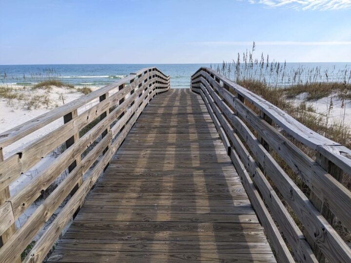 Gulf Shores Alabama boardwalk to white sand beach.