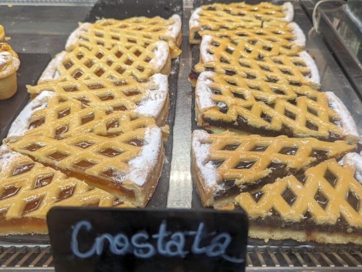 Crostata dessert on display at a bakery in Italy.