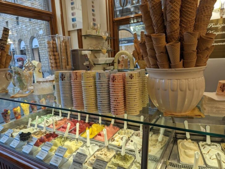 Gelato desserts, cups, and cones, at a gelateria in Florence Italy.