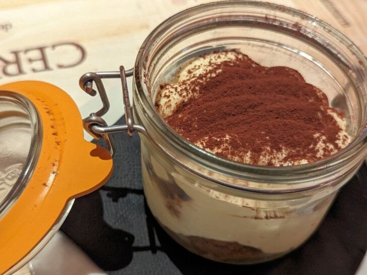 Tiramisu in a jar with the lid open.