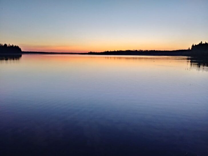 Astotin Lake at sunset with refection in the water.