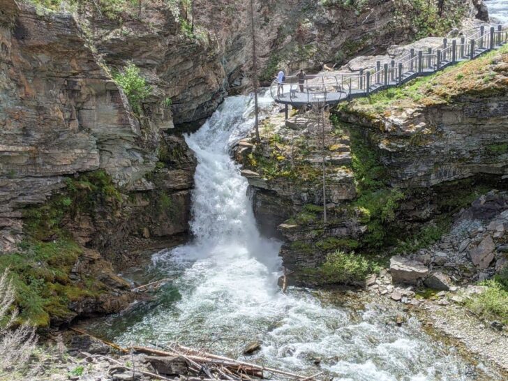 Blakiston Falls and hikers at observation deck overlooking the falls at Waterton Lakes National Park.