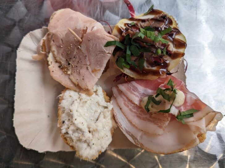 Four cicchetti on a plate in Venice.