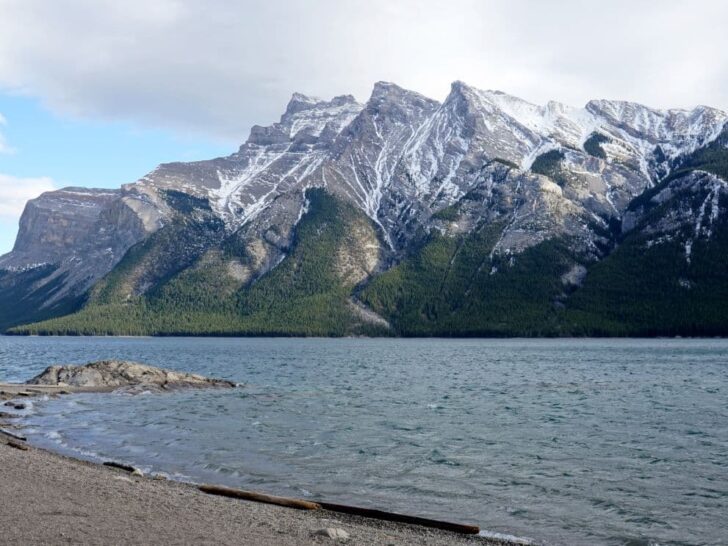 Lake Minnewanka and snow capped Rocky Mountains at Banff National Park Alberta.
