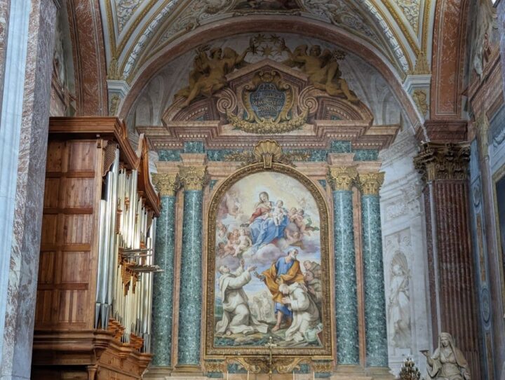 Religious painting and colorful columns of Santa Maria degli Angeli e dei Martiri church in Rome.