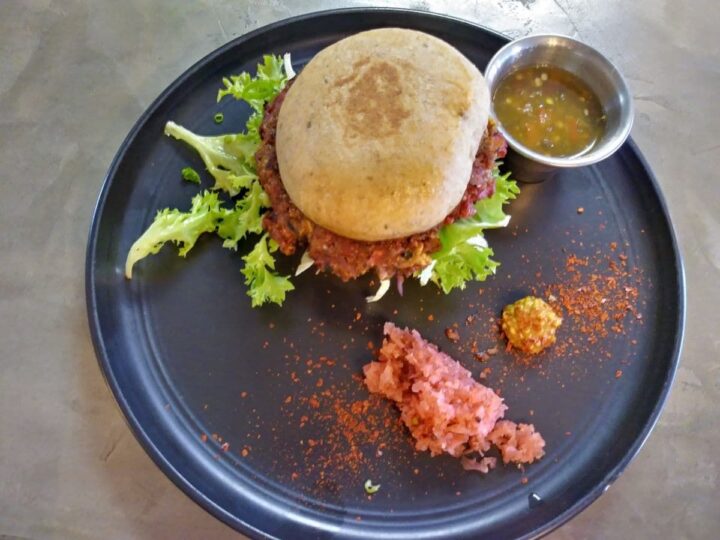 Veggie burger with savory sauce on the side from Scratch Farm Kitchen in Lafayette Louisiana.