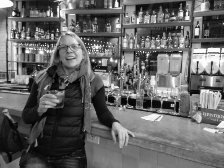 Susan Moore drinking a cocktail at Spoonbill Watering Hole & Restaurant in Lafayette LA.