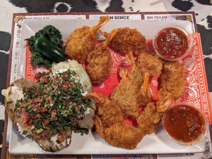Fried shrimp and loaded baked potato on a platter at Big Texan Steak Ranch Amarillo.