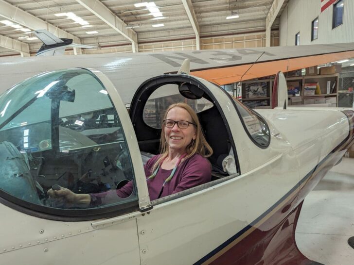 Woman seated in small aircraft at Texas Air & Space Museum in Amarillo.