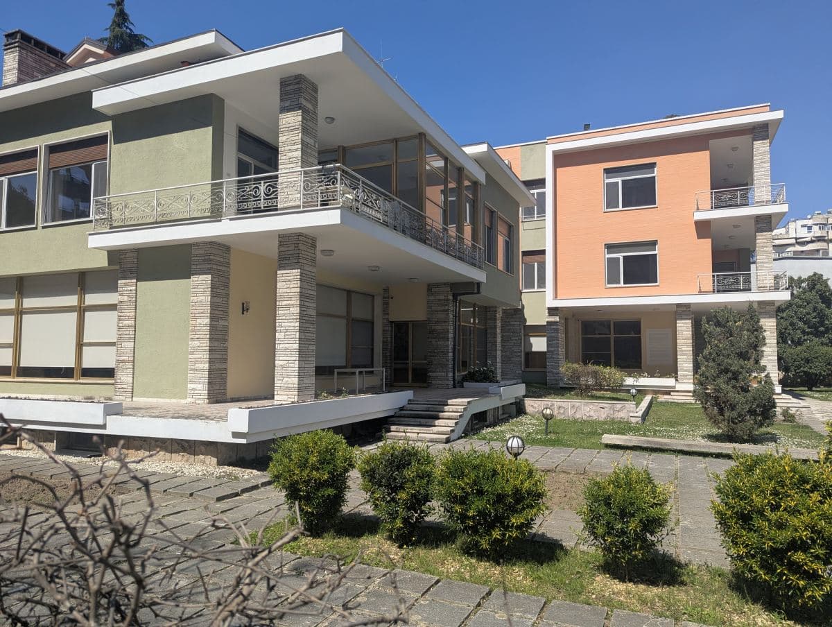 The modernist, multi-level former villa of Albanian dictator Enver Hoxha in the Blloku neighborhood of Tirana on a sunny day.